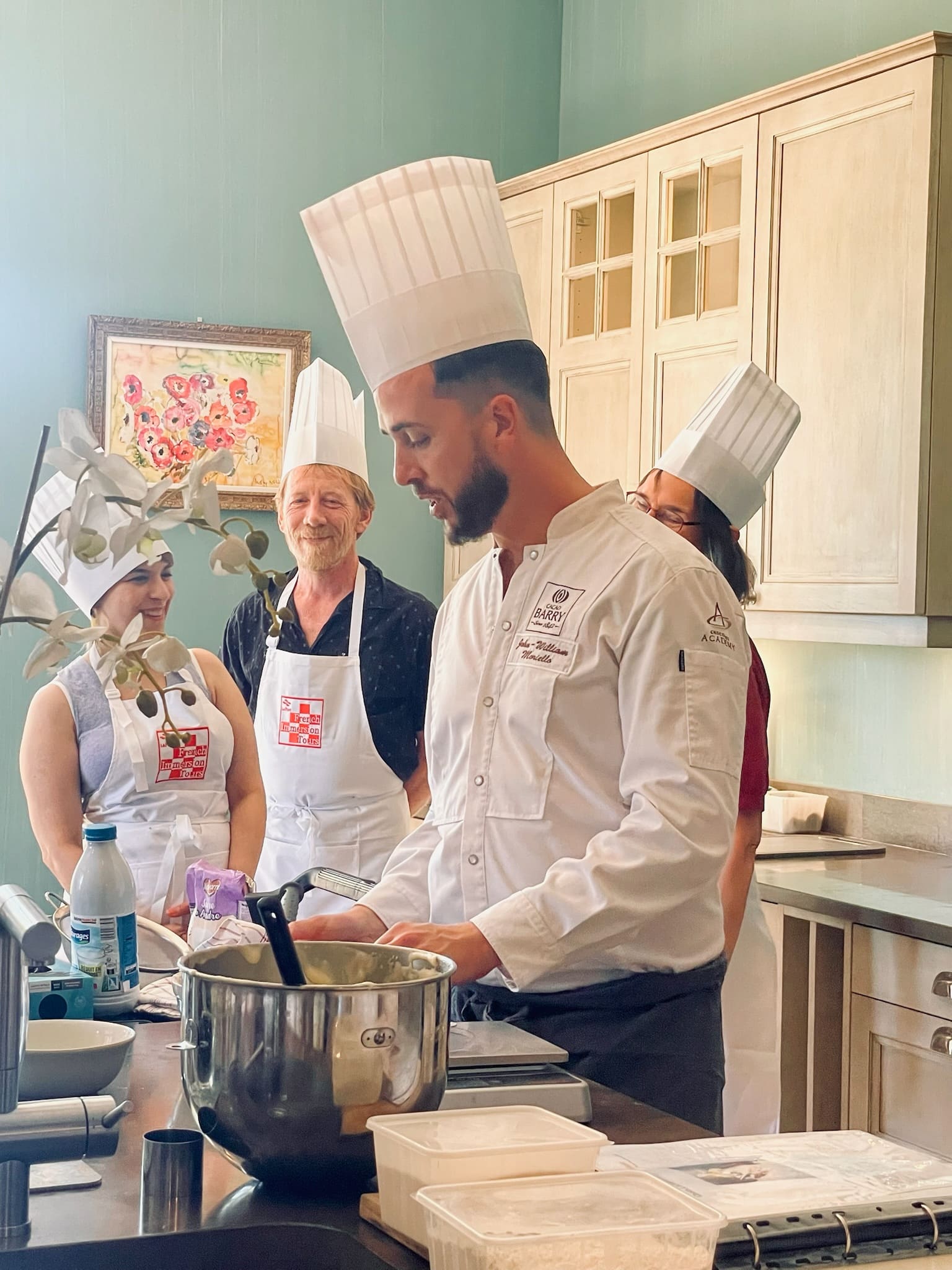 Chef John-William Moniello anime un cours de pâtisserie avec French Immersion Tours dans une cuisine conviviale.